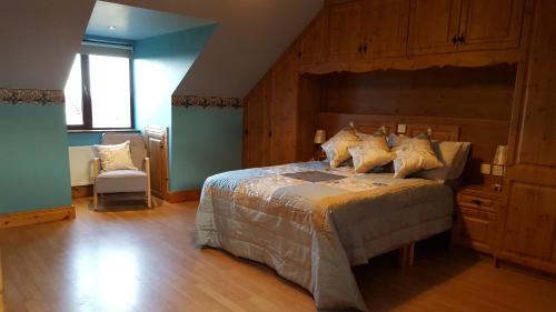 a bedroom with a large bed with a wooden headboard at Leroy´s Lodge in Headford
