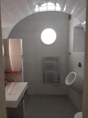 a bathroom with a sink and a toilet and a window at Faro Town House in Faro