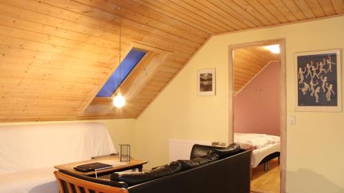 a room with a couch and a desk and a bed at Lovely house in Tórshavn in Tórshavn