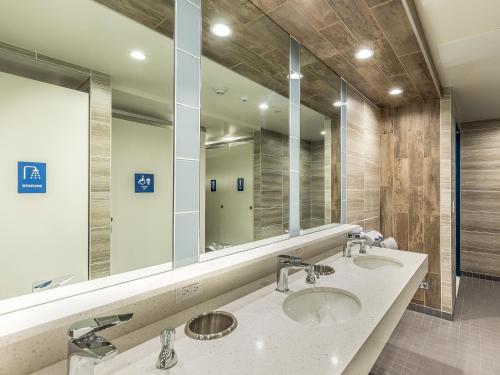 a bathroom with two sinks and a large mirror at HI Los Angeles - Santa Monica Hostel in Los Angeles