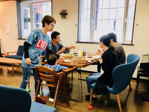 a group of people sitting around a table eating food at Appi Life is Beautiful in Hachimantai