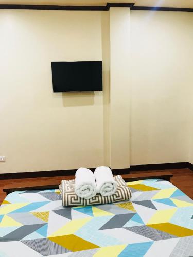 a room with three rolled towels on a rug at Hadassah’s Place in Olango Island