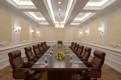 a large conference room with a long table and chairs at Meliá Vinpearl Phu Ly in Phủ Lý