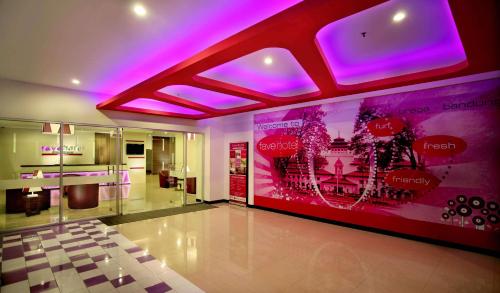 a lobby with purple lights in a building at favehotel Braga in Bandung