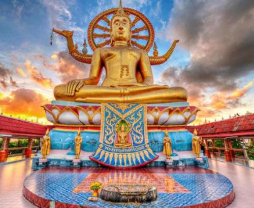 a large golden statue in front of a building at Samui Backpacker Hotel in Bang Rak Beach