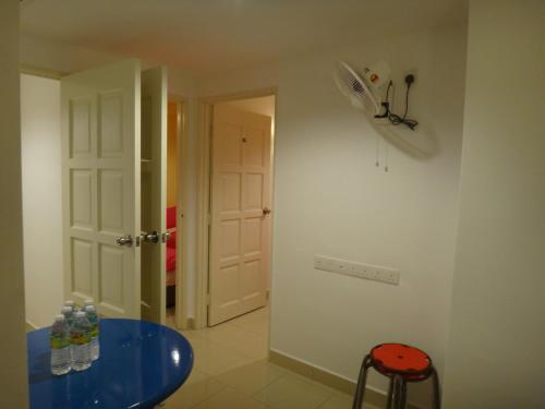 a room with a blue table and a white door at Famosa 2 Stay in Melaka