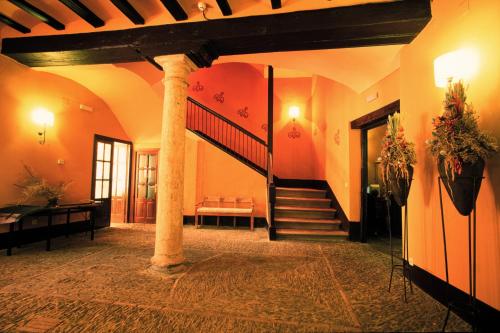 a hallway with a spiral staircase in a building at Posada del Almudí in Daroca