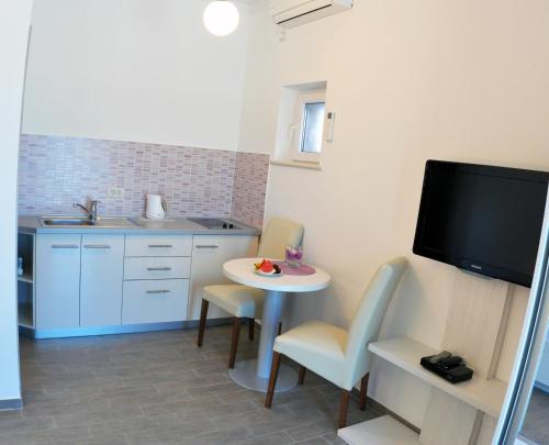 Η κουζίνα ή μικρή κουζίνα στο Paradis Apartments
