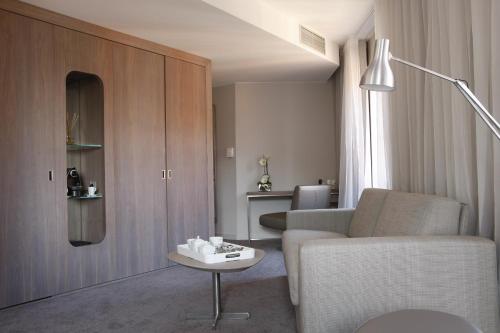 a living room with a couch and a table at Le Grand Balcon Hotel in Toulouse