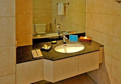 a bathroom with a sink and a toilet at Costabella Tropical Beach Hotel in Mactan