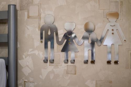 a wall with stick figures of a family on it at Хостел и Апартаменты Друзья in Dnipro