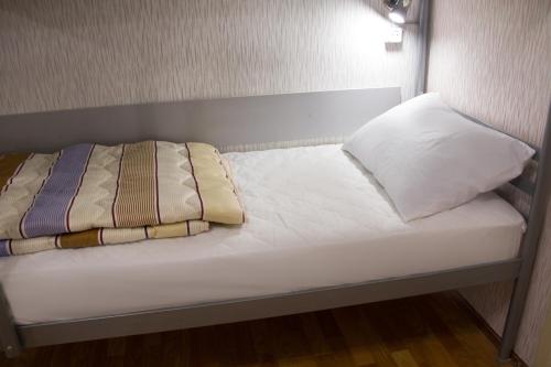 a bed with two pillows on top of it at Хостел и Апартаменты Друзья in Dnipro