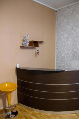 a bar in a room with a yellow stool at Хостел и Апартаменты Друзья in Dnipro