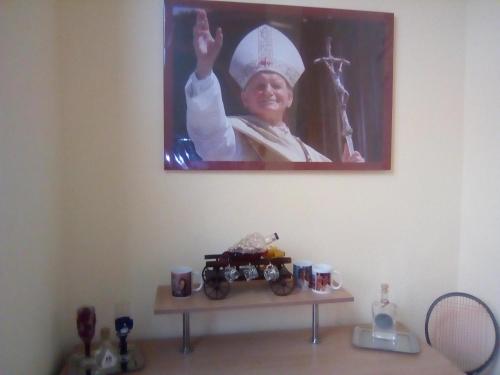 a picture of a nun on the wall above a table at Casa Ovi și Simo in Haţeg