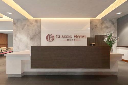 a lobby of a classico hotel with a reception desk at Classic Hotel in Muar