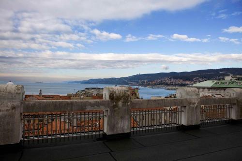 a balcony with a view of the ocean and a city at Residence Liberty in Trieste