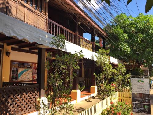 a building with a porch with plants on it at Villa Sayada in Luang Prabang