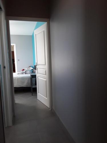 an open door to a bedroom with a bed at Petite suite sympa Avoine in Avoine
