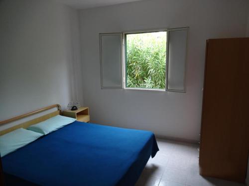 En eller flere senge i et værelse på Villaggio Sabbiadoro