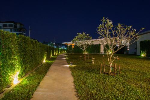 a path in a park at night with lights at Good Night Pool Villa Phuket - SHA Plus in Phuket Town
