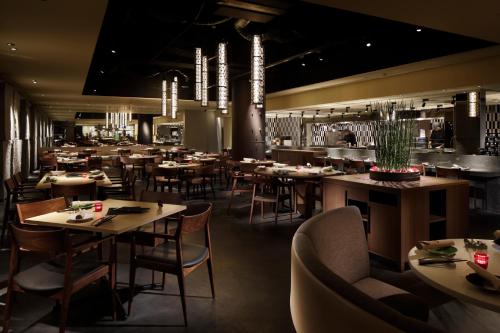 a dining room with tables and chairs and a restaurant at Shinagawa Prince Hotel East Tower in Tokyo