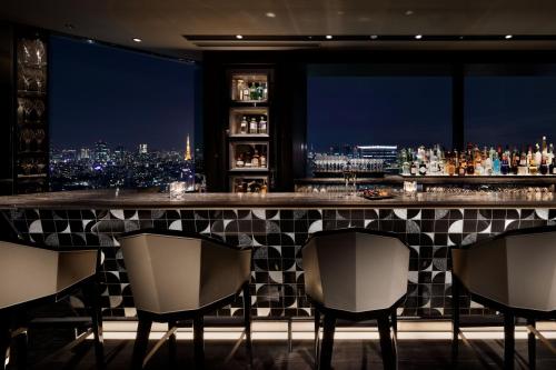 a bar with a view of a city at night at Shinagawa Prince Hotel East Tower in Tokyo