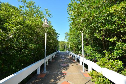 a bridge with a street light and trees at Good Night Pool Villa Phuket - SHA Plus in Phuket Town