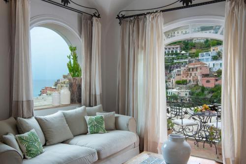 a living room with a couch and a large window at Casa Buonocore in Positano