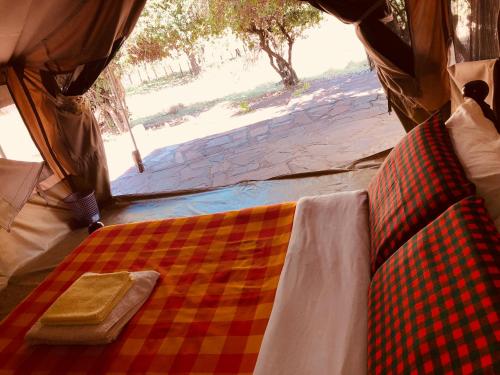 a close up of a bed in a tent at Oldarpoi Wageni Camps in Keekorok