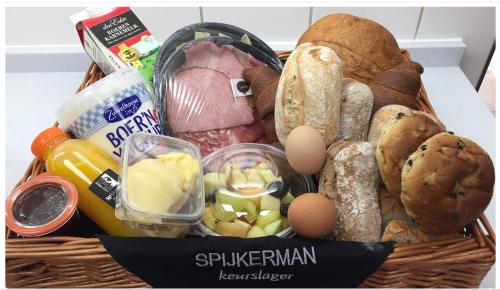 a basket filled with different types of food at Watertorenhotel Nes in Nes