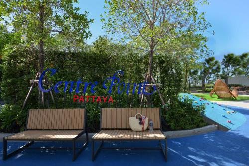a couple of benches in front of a playground at Centre Point Prime Hotel Pattaya in Pattaya North
