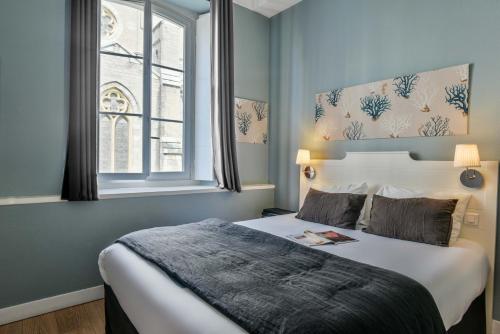 En eller flere senger på et rom på Hotel De L'Océan