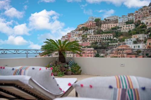 a balcony with two chairs and a mountain at Casa Buonocore in Positano