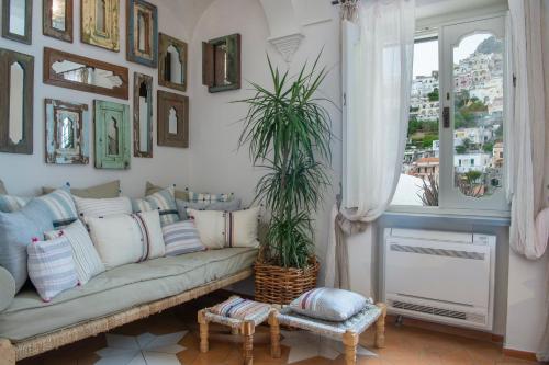 a living room with a couch and a window at Casa Buonocore in Positano