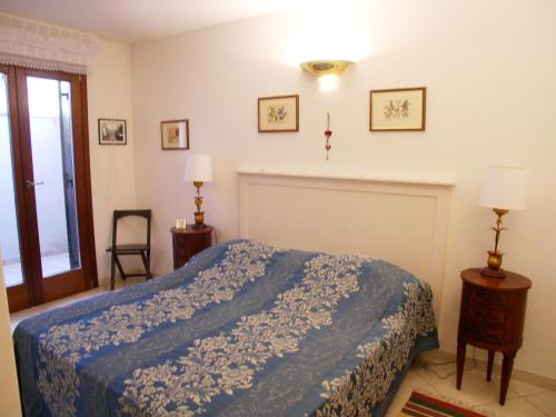 a bedroom with a bed with a blue blanket at Residence Gloria in Grado