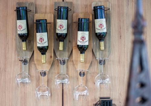 a group of wine glasses hanging on a wall at Green Pix Khaoyai in Pak Chong