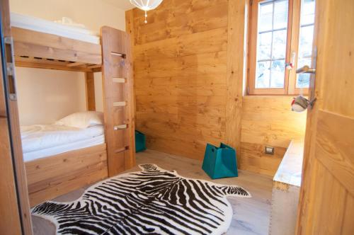 a zebraebra rug in a room with a bunk bed at Chalet Riquet - Ski/in-out - Jacuzzi in Nendaz
