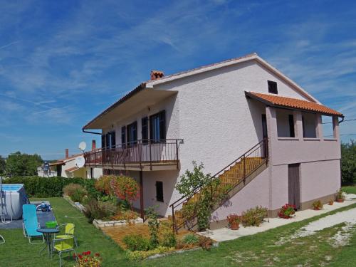 a white house with a dog on the roof at Comfortable and quiet apartment in Istria with privacy in Šajini