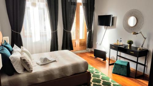 a bedroom with a bed with a mirror and a window at Cool Guesthouse in Porto