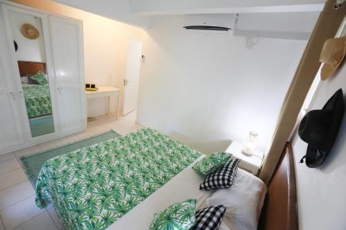 a small bedroom with a bed and a window at Chantauvent Guest House in Blue Bay
