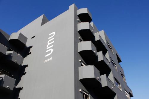 a building with balconies on the side of it at Hotel Umu in Santarém