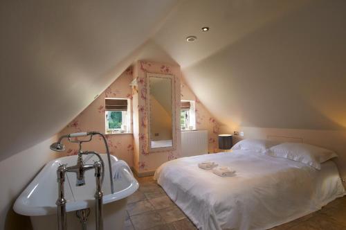 a bedroom with a bed and a bath tub at The Museum Inn in Farnham