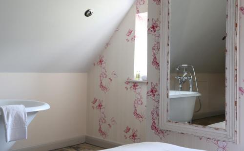 a bathroom with a sink and a mirror at The Museum Inn in Farnham