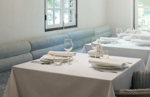 two white tables with glasses and plates and napkins at The Apsara in Luang Prabang