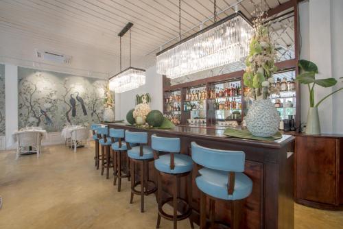 a bar with blue bar stools in a restaurant at The Apsara in Luang Prabang