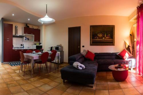 a living room with a couch and a table at House Etna View in Mascali