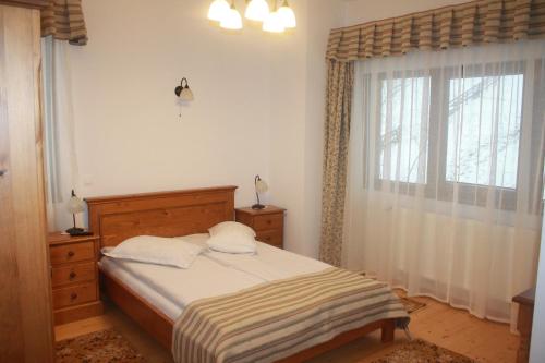 a bedroom with a bed and a window at Arnica Montana in Arieşeni