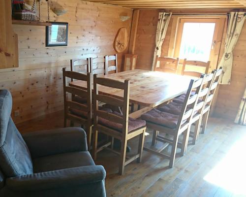 - une salle à manger avec une table et des chaises en bois dans l'établissement Gîte l'Ermitage, à Veysonnaz
