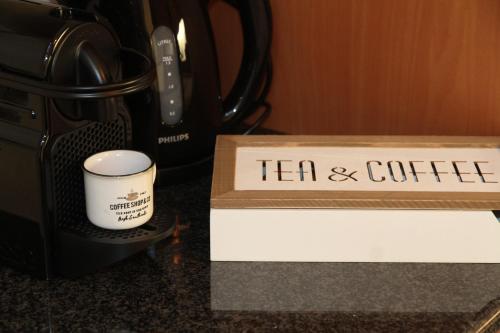 a tea container and a cup on a counter at Hoogpoort Residence George in Ghent