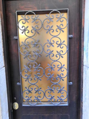 a door with a wrought iron gate on it at Appartamento AlCova in Venice